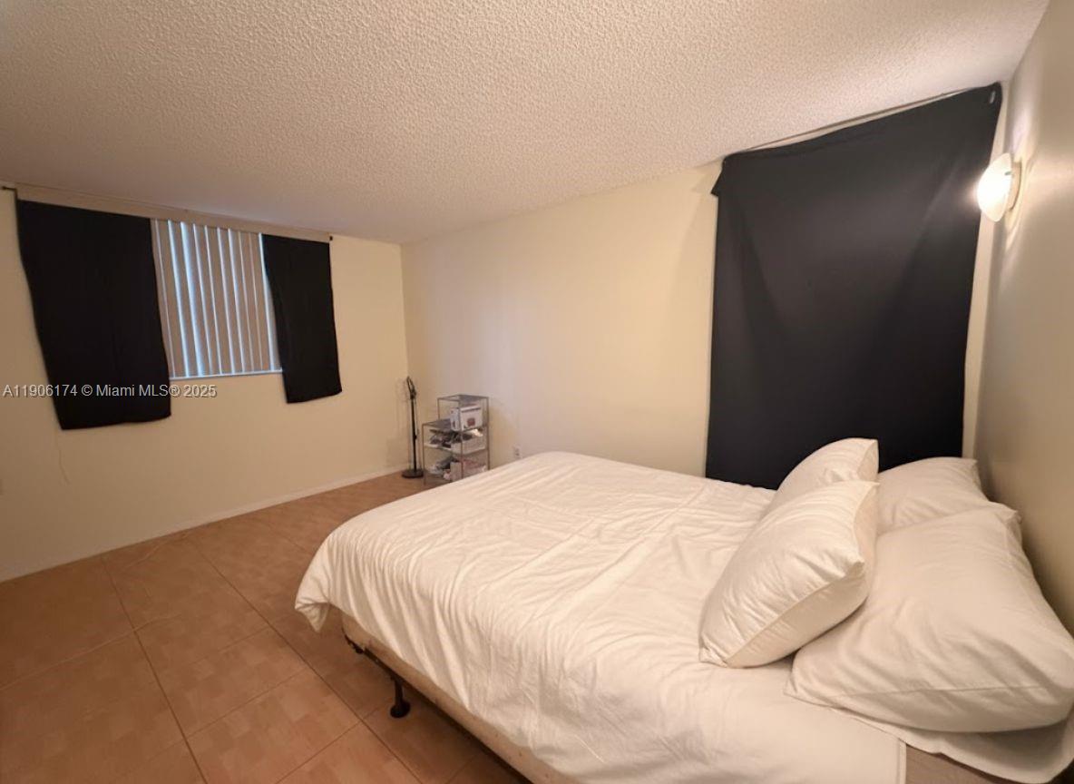 1820 Southwest 81st Avenue, Unit 3107 North Lauderdale, FL 33068 - Photo 11 of 25 a bedroom with a bed and mirror