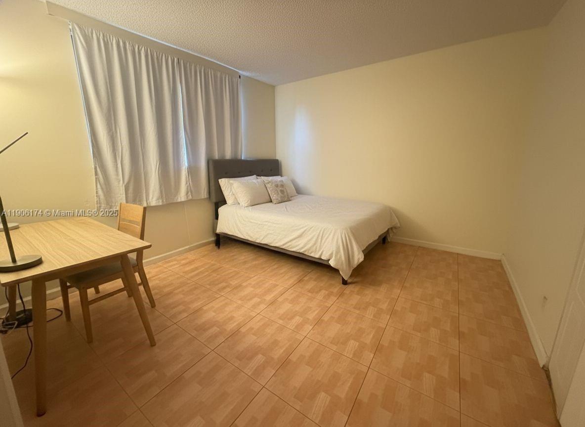 1820 Southwest 81st Avenue, Unit 3107 North Lauderdale, FL 33068 - Photo 12 of 25 a spacious bedroom with a bed and a table in it