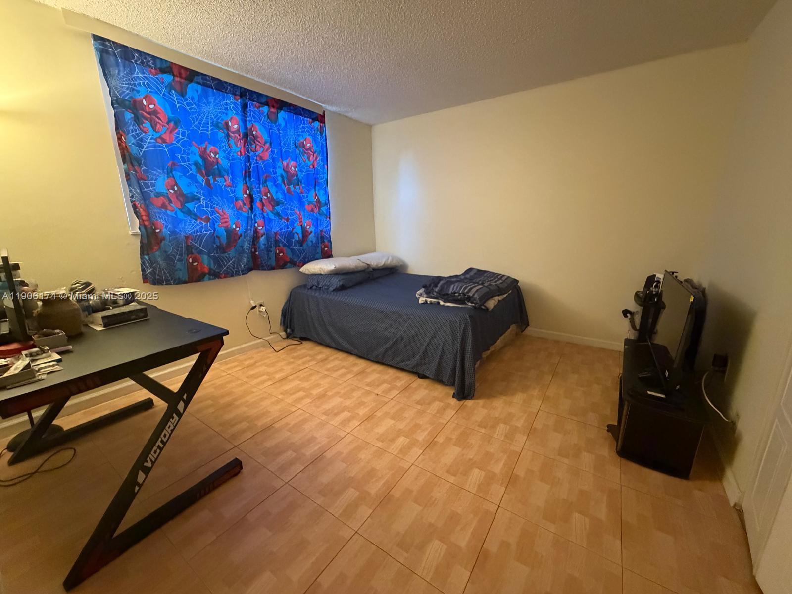 1820 Southwest 81st Avenue, Unit 3107 North Lauderdale, FL 33068 - Photo 13 of 25 a bedroom with a bed and dresser