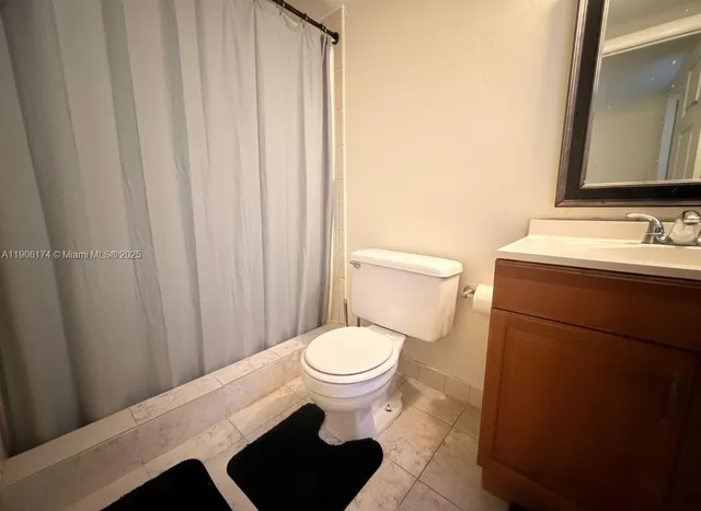 a bathroom with a toilet a sink and a mirror