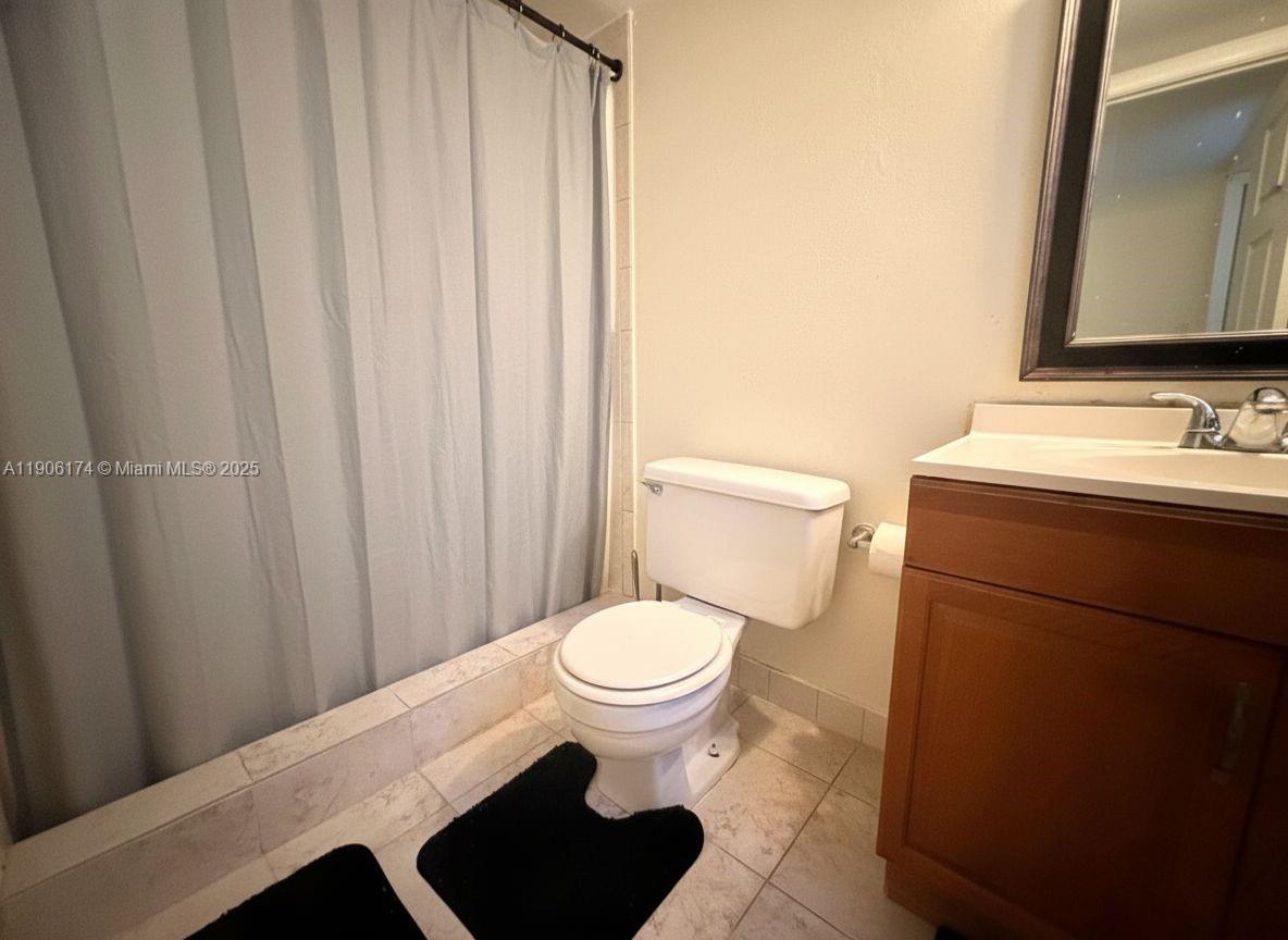 1820 Southwest 81st Avenue, Unit 3107 North Lauderdale, FL 33068 - Photo 16 of 25 a bathroom with a toilet a sink and a mirror
