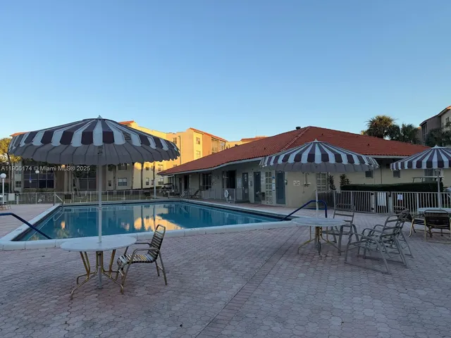 a backyard of a house with table and chairs