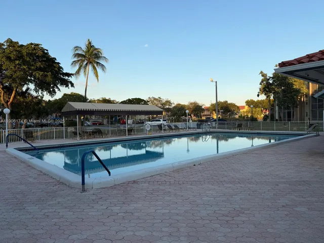 a view of a swimming pool with a table and chairs
