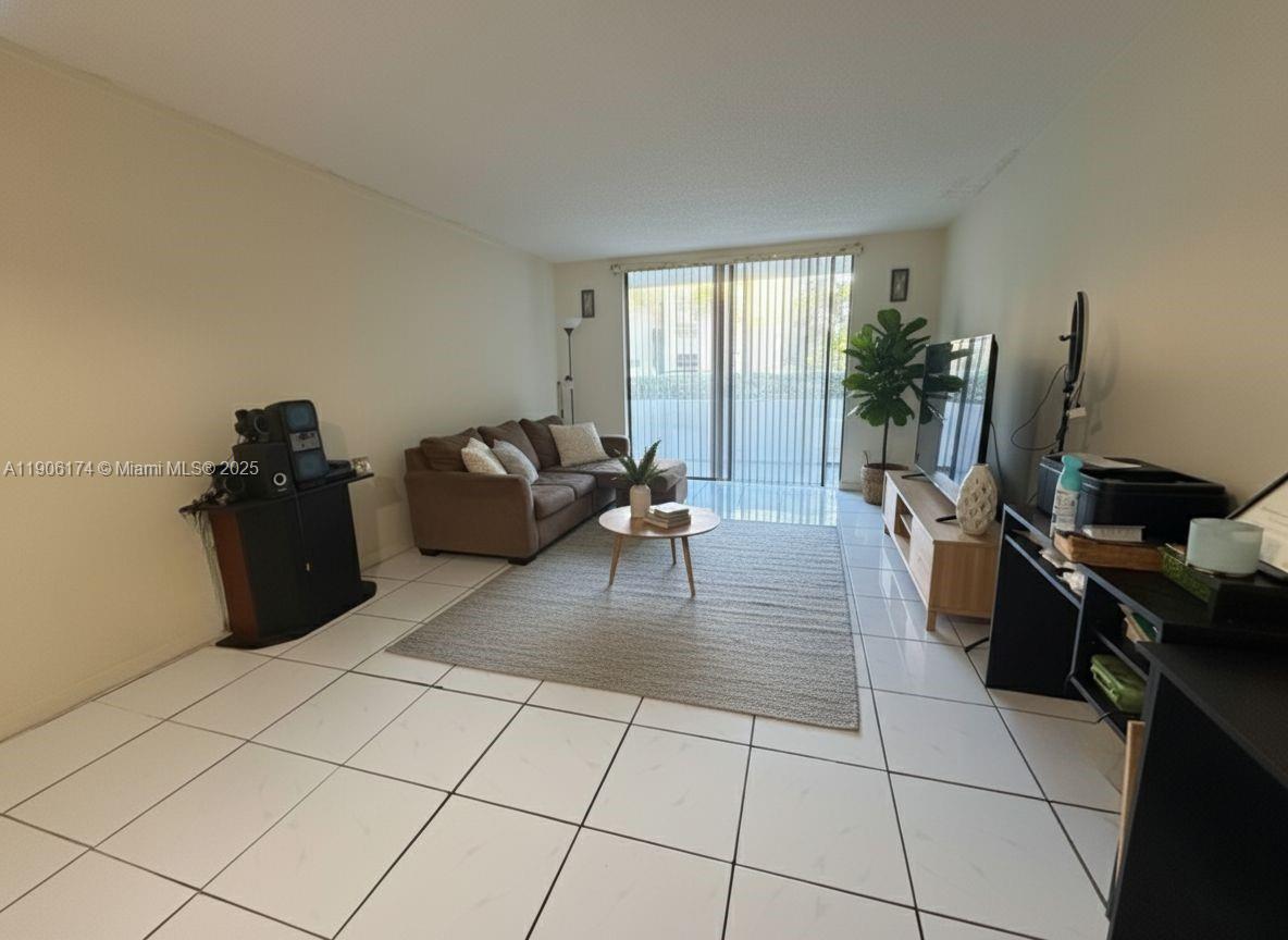 1820 Southwest 81st Avenue, Unit 3107 North Lauderdale, FL 33068 - Photo 6 of 25 a kitchen with granite countertop a stove a sink a refrigerator and glass door
