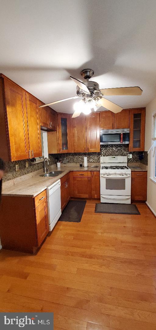 8512 Imperial Drive, Unit 1H Laurel, MD 20708 - Photo 7 of 14 a kitchen with granite countertop a stove top oven and cabinets