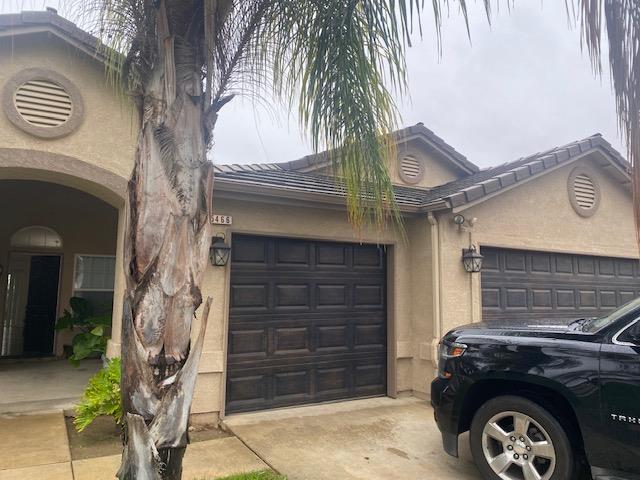 a front view of a house with parking space