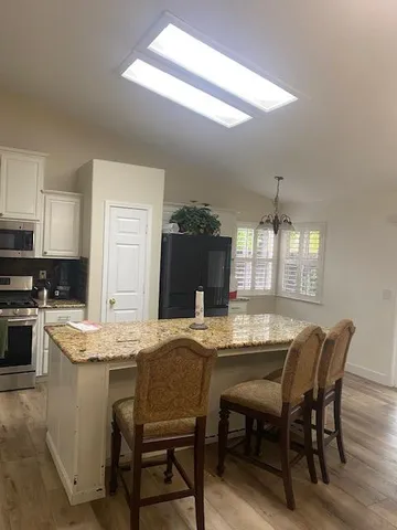 a dining table with chairs and wooden floor
