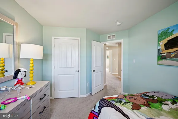 a bedroom with a bed and a dresser in it