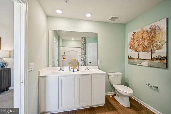 a bathroom with a toilet a sink and mirror
