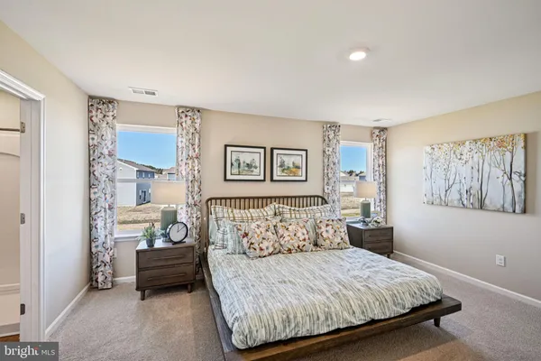 a bedroom with a bed and window