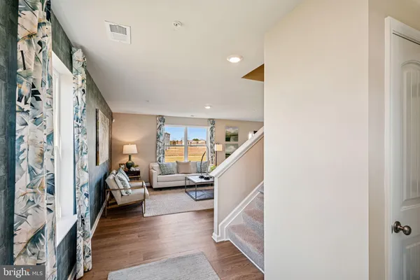 a living room with furniture and stairs
