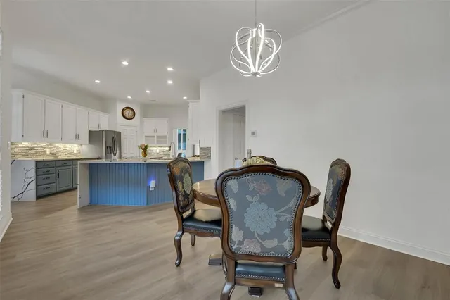 a view of a dining room with furniture and chandelier