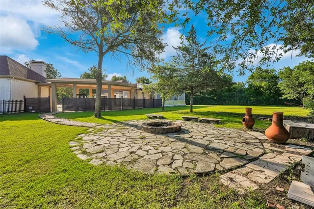 a view of a swimming pool with a patio and a yard