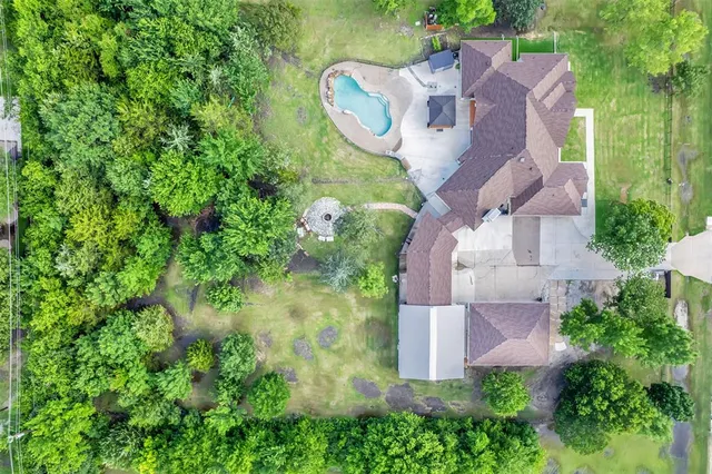 an aerial view of a house with garden space and street view