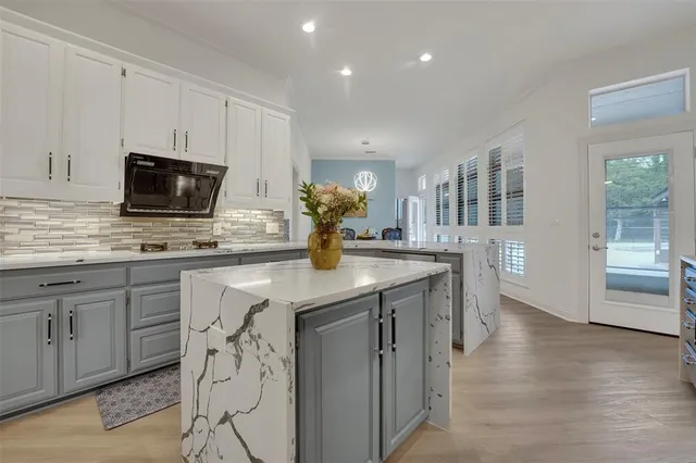 a kitchen with stainless steel appliances granite countertop a stove and a sink