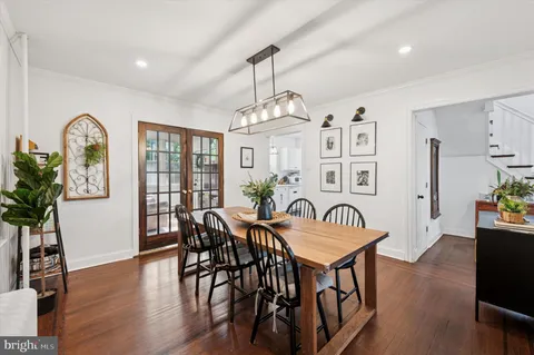 a view of a a dining room with furniture window and wooden floor