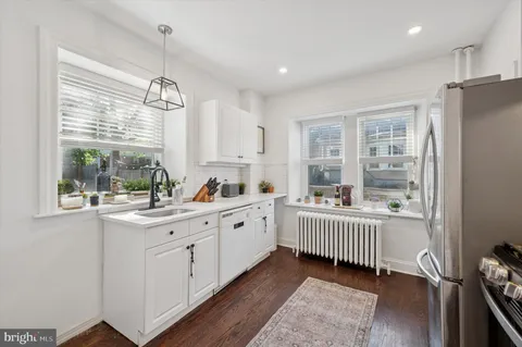 a kitchen with counter top space and window