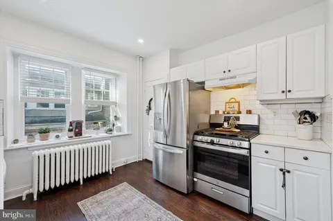 a kitchen with stainless steel appliances a stove a sink and a refrigerator