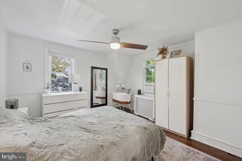 a bedroom with a bed and a refrigerator