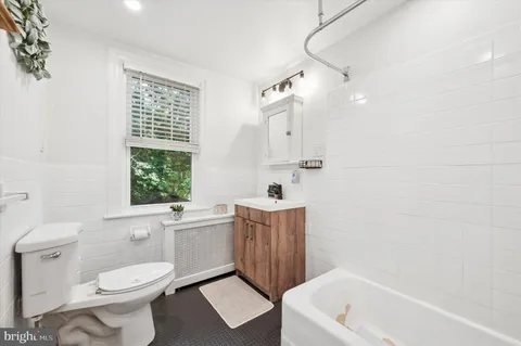 a bathroom with a sink a toilet and a bathtub