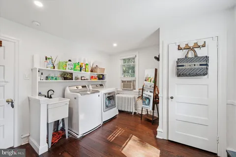a kitchen with a sink cabinets and wooden floor