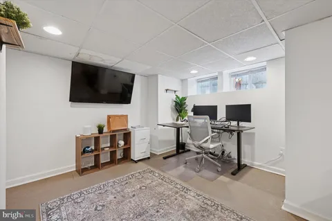 a view of a livingroom with workspace and a window