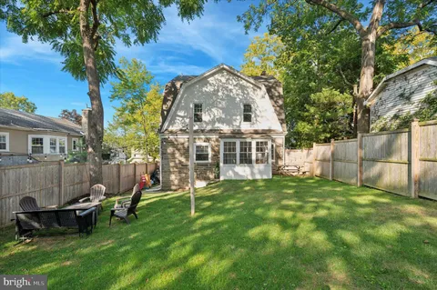 a view of a house with a backyard and a patio