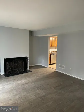 a view of empty room with a fireplace
