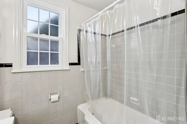 a bathroom with a white bath tub and a shower