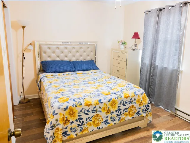 a bedroom with a bed and a window