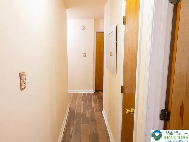 a view of closet with wooden floor