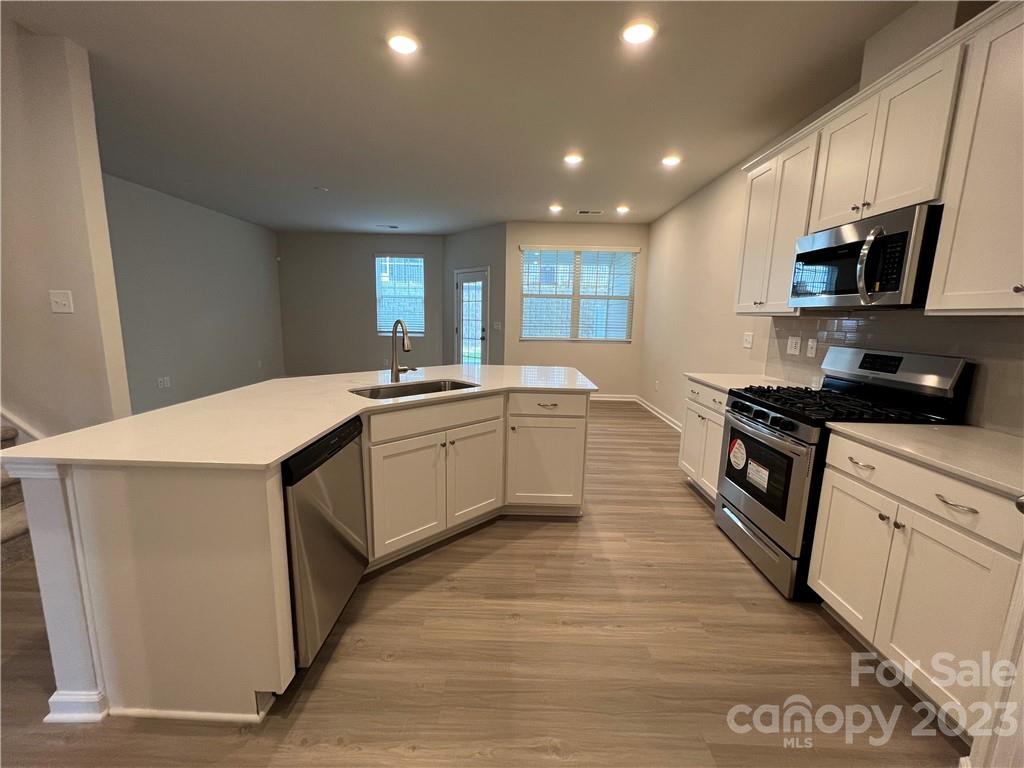 7005 Everly Commons Lane, Unit 2017 Tega Cay, SC 29708 - Photo 4 of 12 a kitchen with a sink a microwave and cabinets