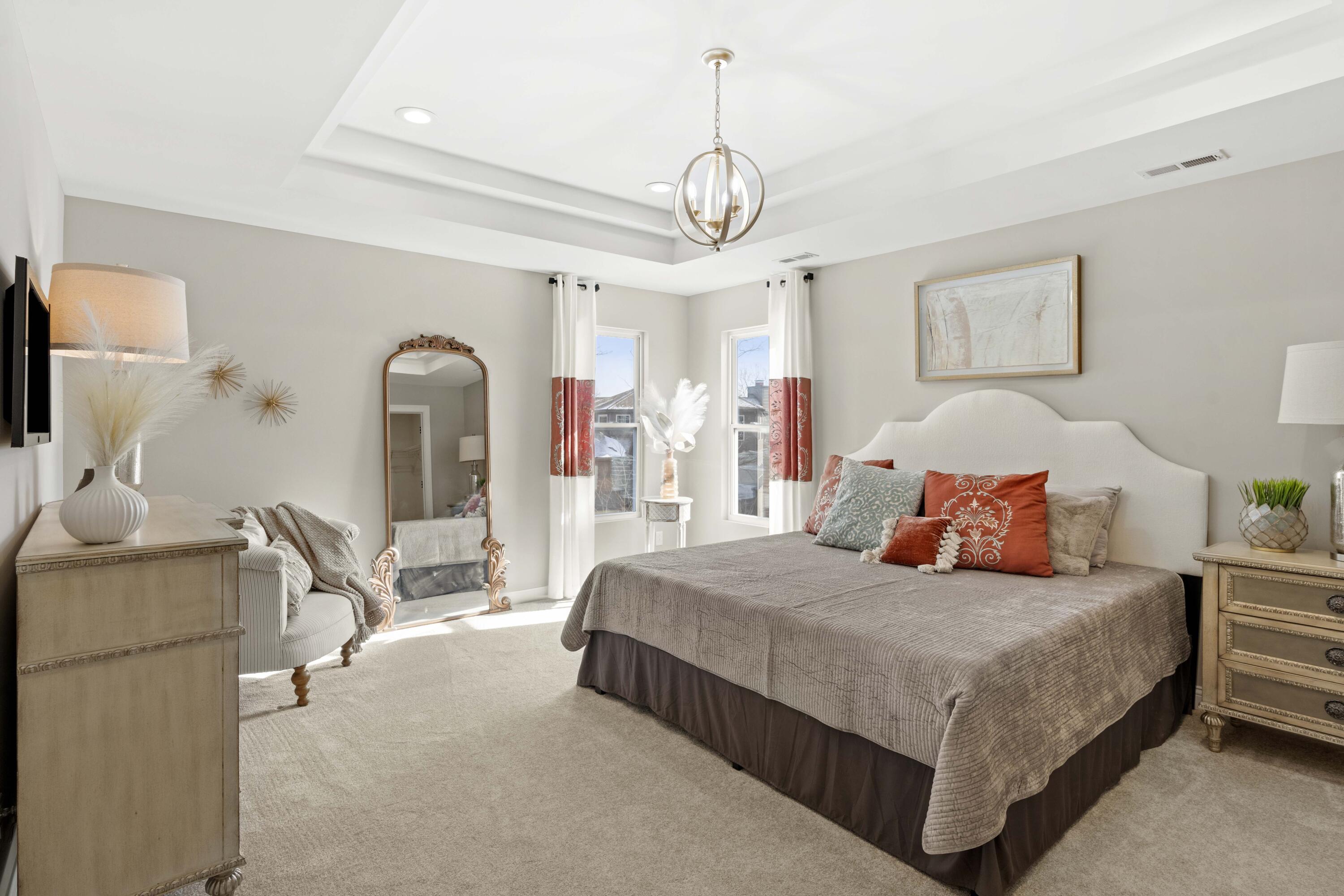 10534 California Street Crown Point, IN 46307 - Photo 19 of 23 a bedroom with a large bed a chandelier and windows