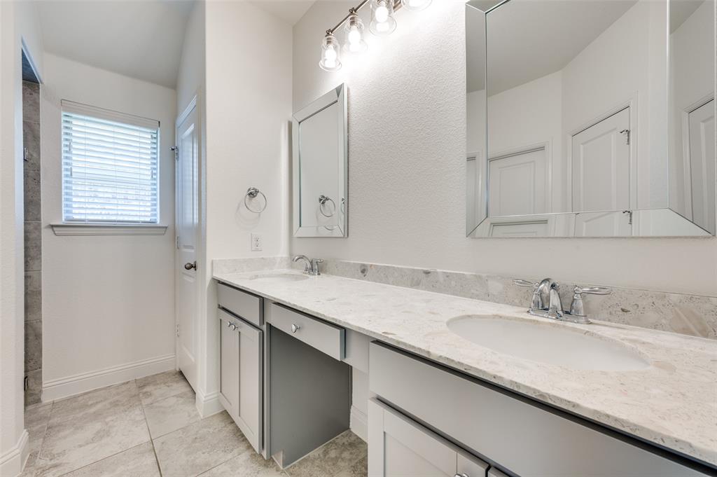 7025 Trailhead Street Little Elm, TX 76227 - Photo 16 of 25 a bathroom with a sink and a mirror