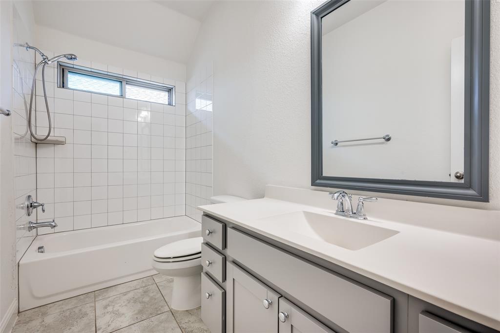 7025 Trailhead Street Little Elm, TX 76227 - Photo 23 of 25 a bathroom with a sink and a mirror