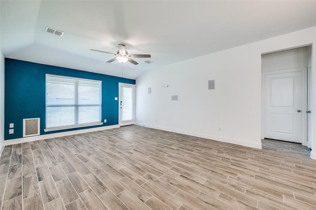 7025 Trailhead Street Little Elm, TX 76227 - Photo 4 of 25 a view of empty room with wooden floor and fan