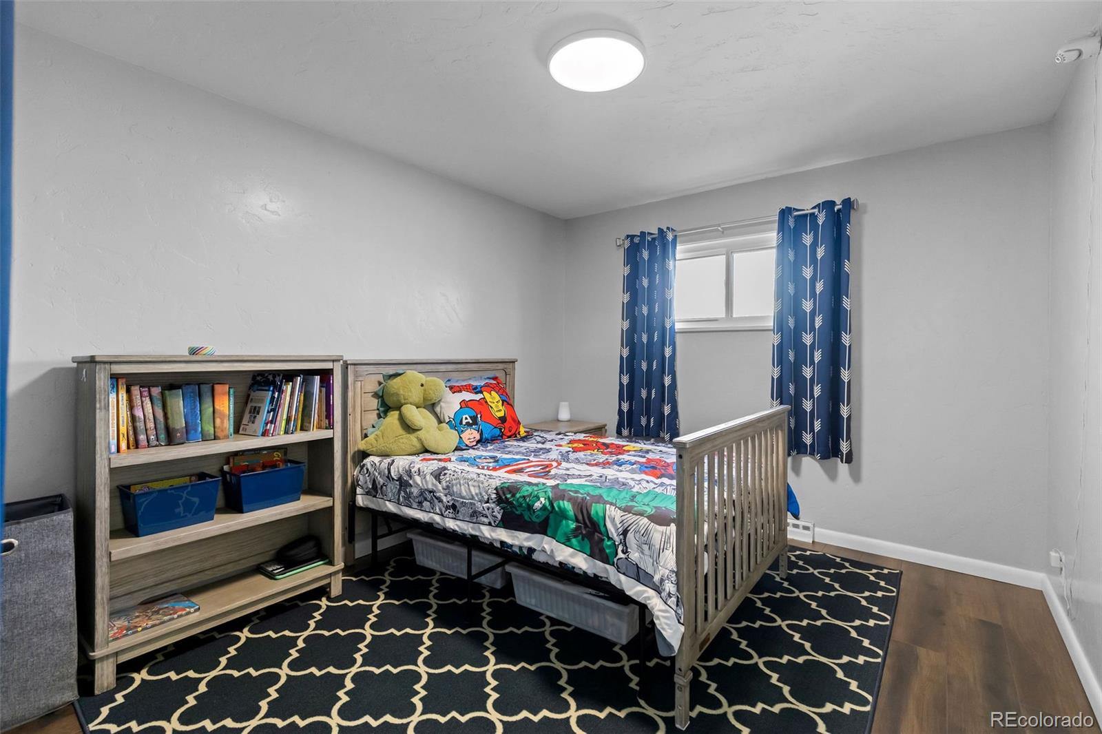 648 South 3rd Avenue Brighton, CO 80601 - Photo 10 of 26 a bedroom with furniture and book shelf