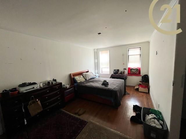 2425 Kings Highway, Unit 8E Brooklyn, NY 11210 - Photo 7 of 9 a living room with furniture and a mirror