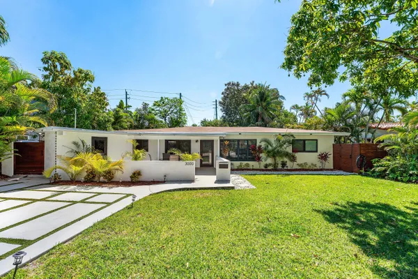 a front view of house with yard and outdoor seating