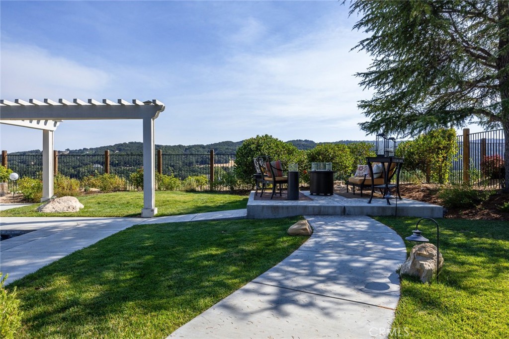 1549 Via Rojas Templeton, CA 93465 - Photo 4 of 29 a view of a patio with a table and chairs potted plants and palm trees