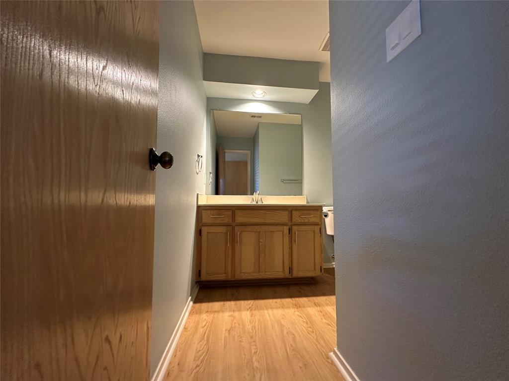 724 Cory Street Grapevine, TX 76051 - Photo 13 of 16 a bathroom with a sink and a mirror