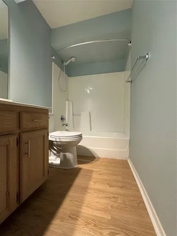 a bathroom with a sink a toilet and mirror