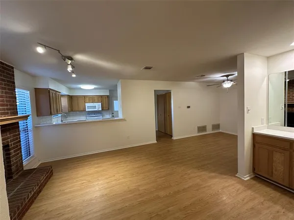 a view of a kitchen with a sink and a large window
