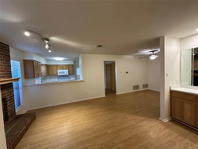 a view of a kitchen with a sink and a large window
