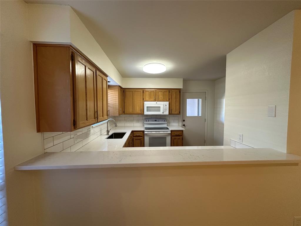 724 Cory Street Grapevine, TX 76051 - Photo 6 of 16 a kitchen with stainless steel appliances a sink a stove and a refrigerator