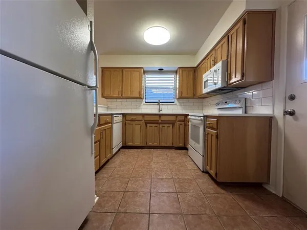 a kitchen with stainless steel appliances granite countertop a sink and cabinets