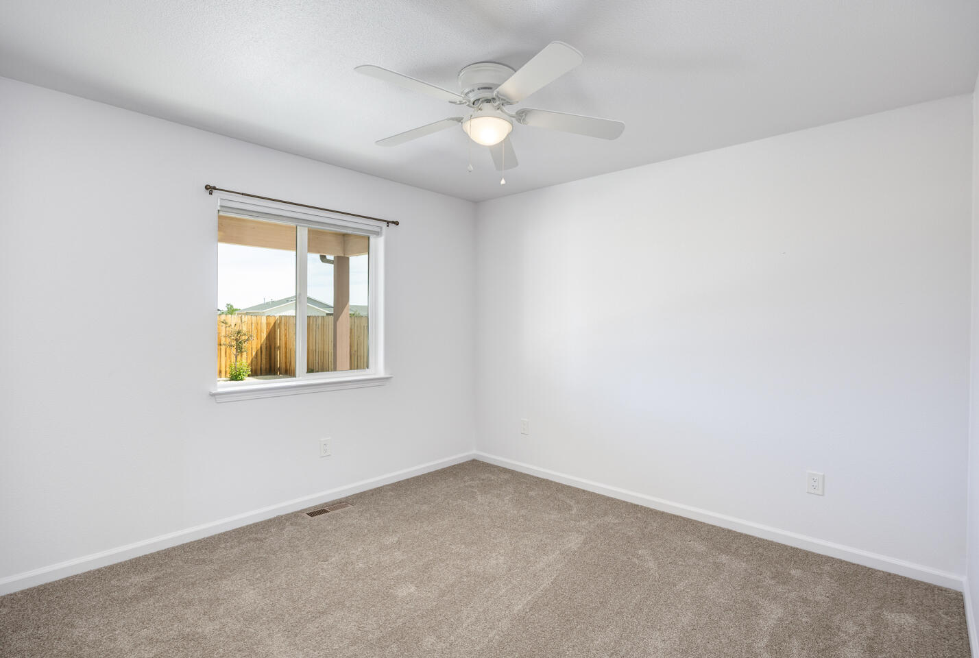772 Megan Way Fallon, NV 89406 - Photo 11 of 22 an empty room with windows and ceiling fan