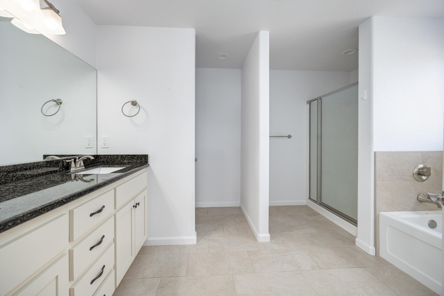 772 Megan Way Fallon, NV 89406 - Photo 13 of 22 a spacious bathroom with a granite countertop sink a mirror and a bathtub