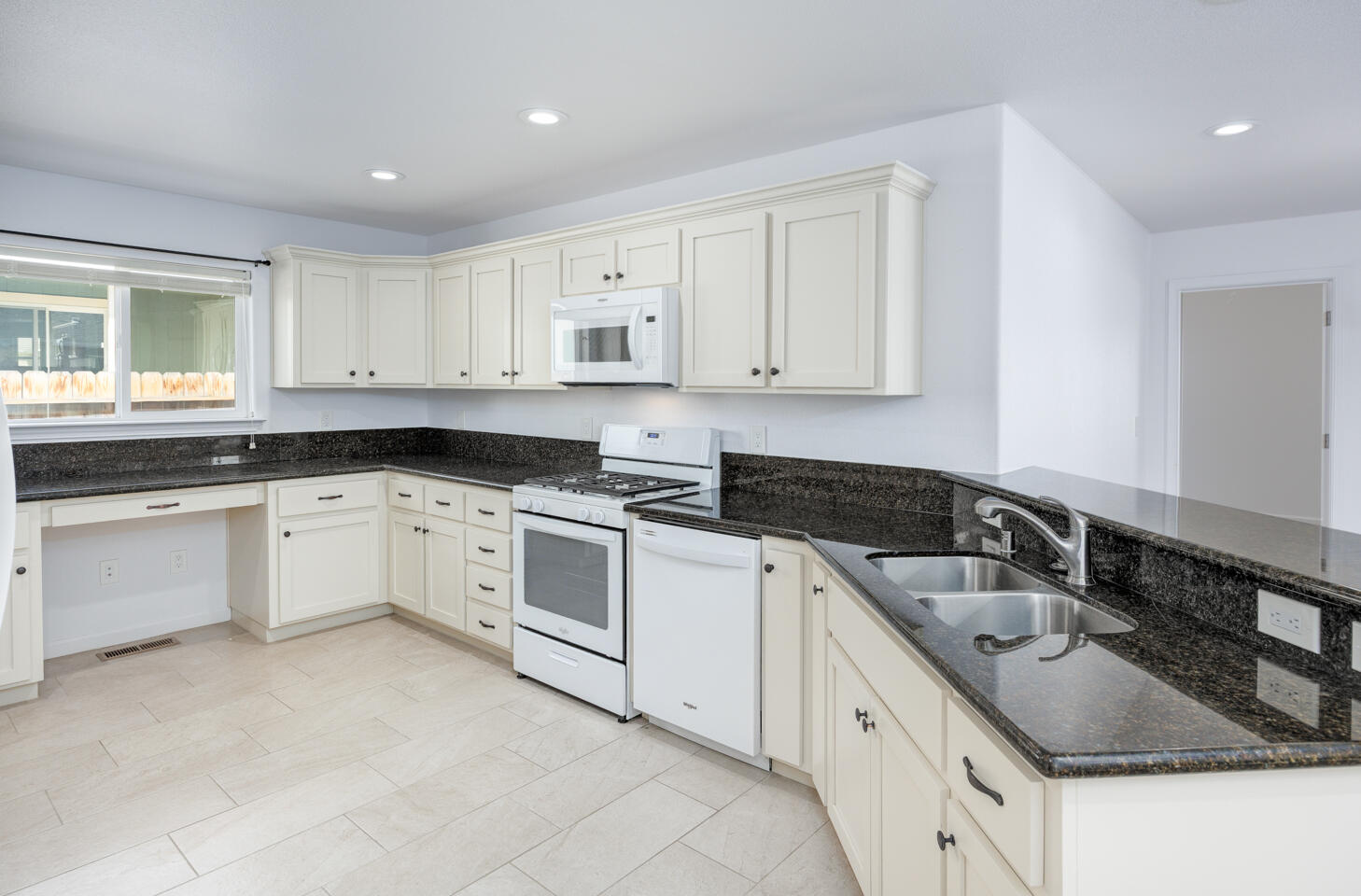 772 Megan Way Fallon, NV 89406 - Photo 6 of 22 a white kitchen with granite countertop white cabinets and white stainless steel appliances