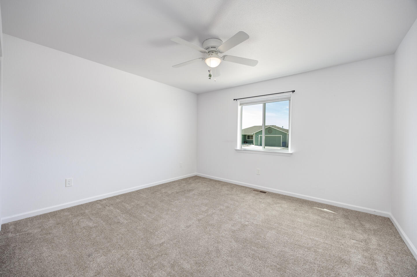 772 Megan Way Fallon, NV 89406 - Photo 9 of 22 an empty room with a window and a ceiling fan